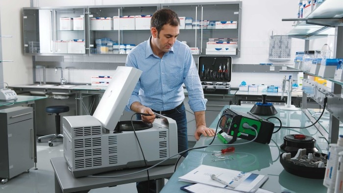 man_inspects_centrifuge