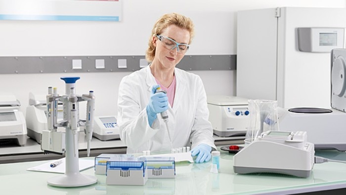 Scientist taking care about ergonomically lab workflows at her personal bench