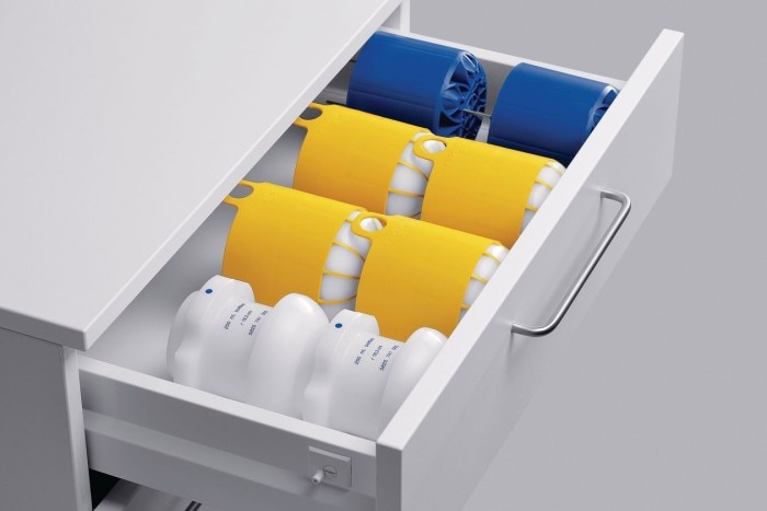 Drawer full of centrifuge adapters in blue, yellow, and white.