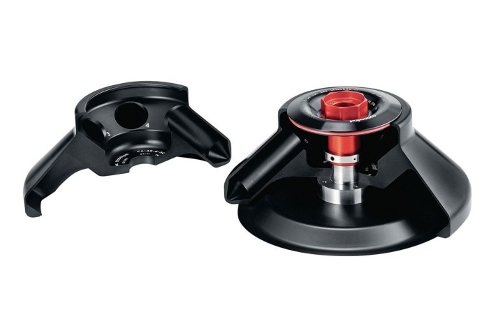 A black centrifuge rotor lid with a red knob symbolizing aerosol-tightness.