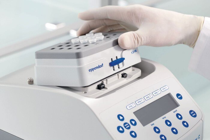 Scientist exchanges thermoblock of an Eppendorf Thermomixer instrument.