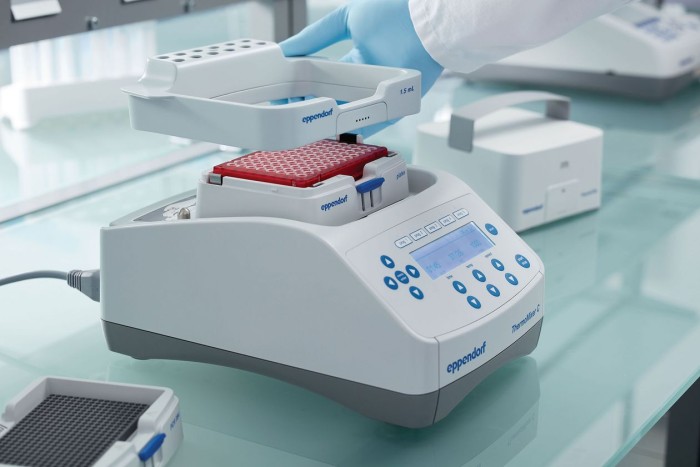 Scientist installs further equipment at Eppendorf ThermoMixer.