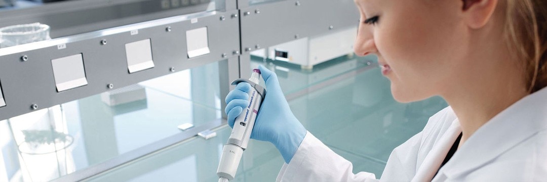 A female scientist using a Research Plus pipette by Eppendorf.