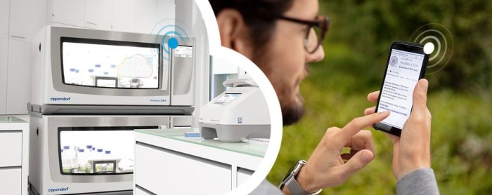 Man using a phone to remotely monitor the temperature of the biological shaker in the laboratory.