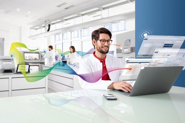 Man at the bench using the laboratory monitoring system to control the intelligent lab.