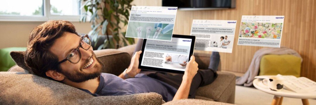 Man using tablet to monitor his lab remotely while reading scientific articles