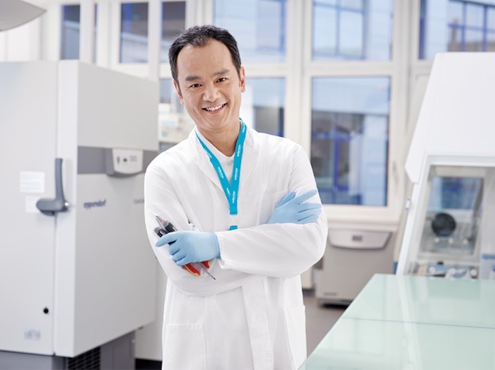 Eppendorf service member standing in the lab to execute ultra low temperature freezer repair and preventive maintenance services