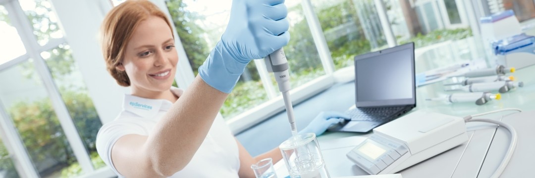 Woman calibrating a pipette in the lab