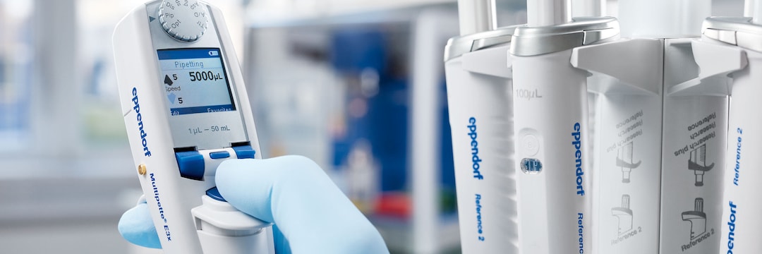 Close-up of Multipette® E3x multi-dispenser and Pipette Carousel 2 with several Eppendorf pipettes